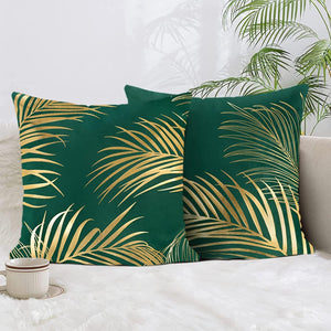 Green decorative square cushion cover with a luxurious gold leaf pattern on soft velve