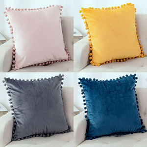 Soft velvet cushion cover featuring pom pom accents for stylish interiors.