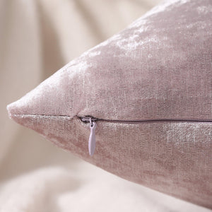 Close-up of pink crushed velvet fabric with shimmering texture on cushion covers