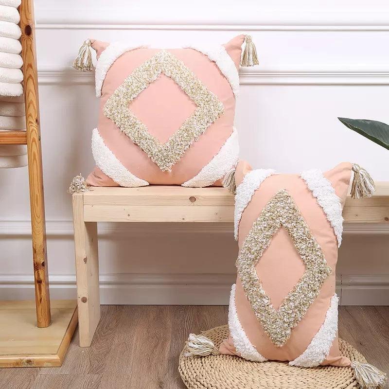 Pink bohemian cushion cover with tufted geometric pattern and tassel accents